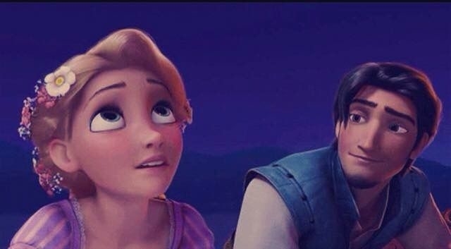 Rapunzel in a purple dress with flowers in her hair, Flynn Rider in a vest, both looking to their left