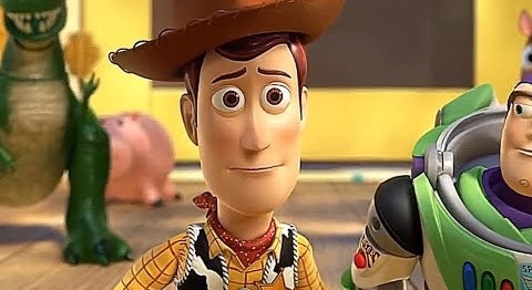 Woody and Buzz Lightyear from Toy Story stand with other characters in the background