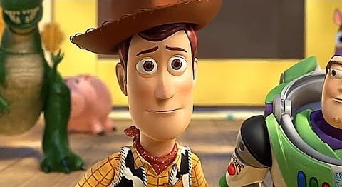 Woody and Buzz Lightyear from Toy Story stand with other characters in the background