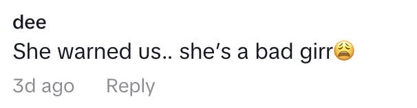 The image displays a social media comment reading "She warned us… she's a bad girrr" with a sad face emoji, posted by a user named dee