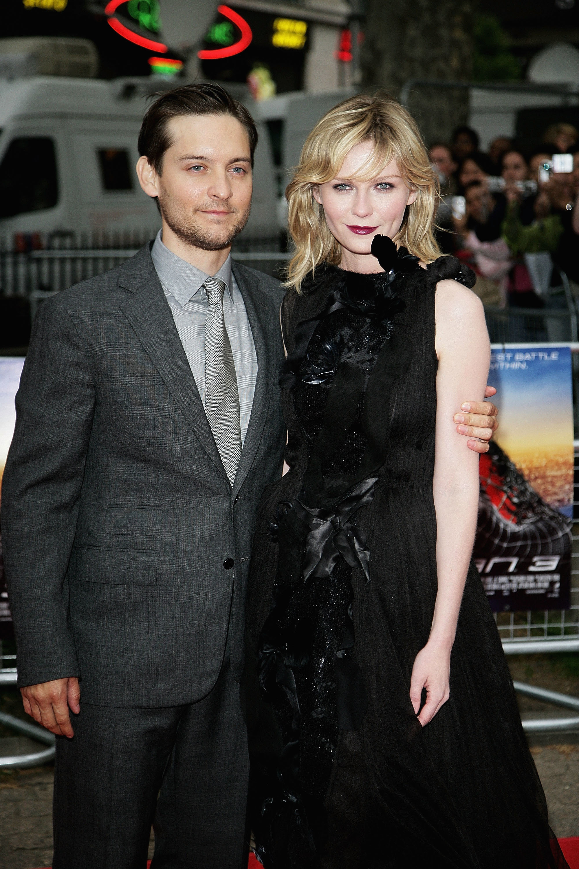 Tobey Maguire and Kirsten Dunst standing together; he&#x27;s in a gray suit, she&#x27;s in a black ruffled dress