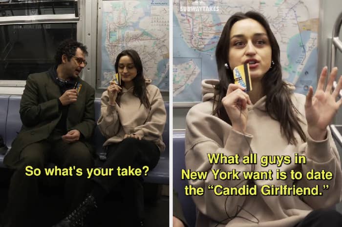 Two people are seated in a subway car, a man listening intently as a woman, who is holding a snack bar, gestures while speaking