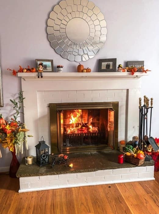 same reviewer's refreshed fireplace after using the whitewash brick paint