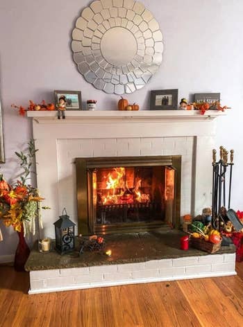 same reviewer's refreshed fireplace after using the whitewash brick paint