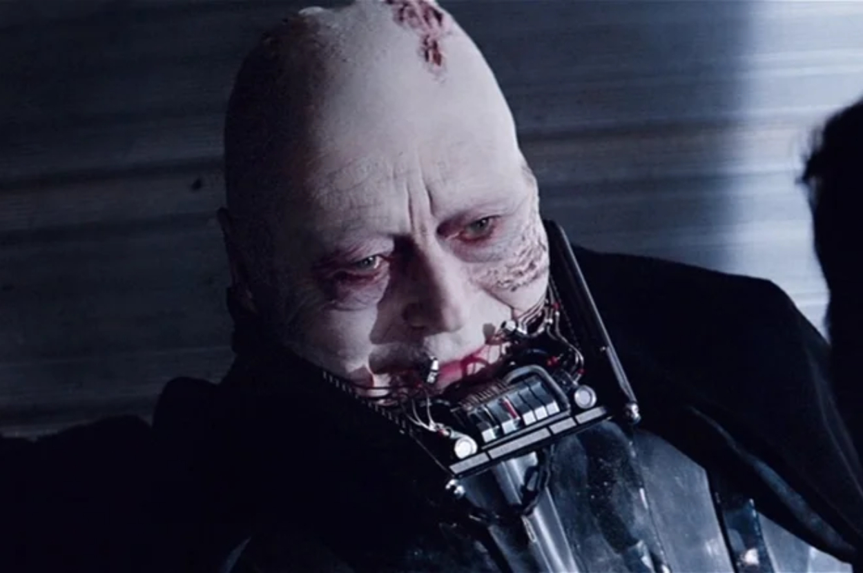 Close-up of Darth Vader without his helmet, revealing scars and breathing apparatus