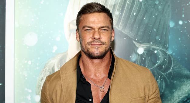 Alan Ritchson wearing a casual jacket and shirt at an event