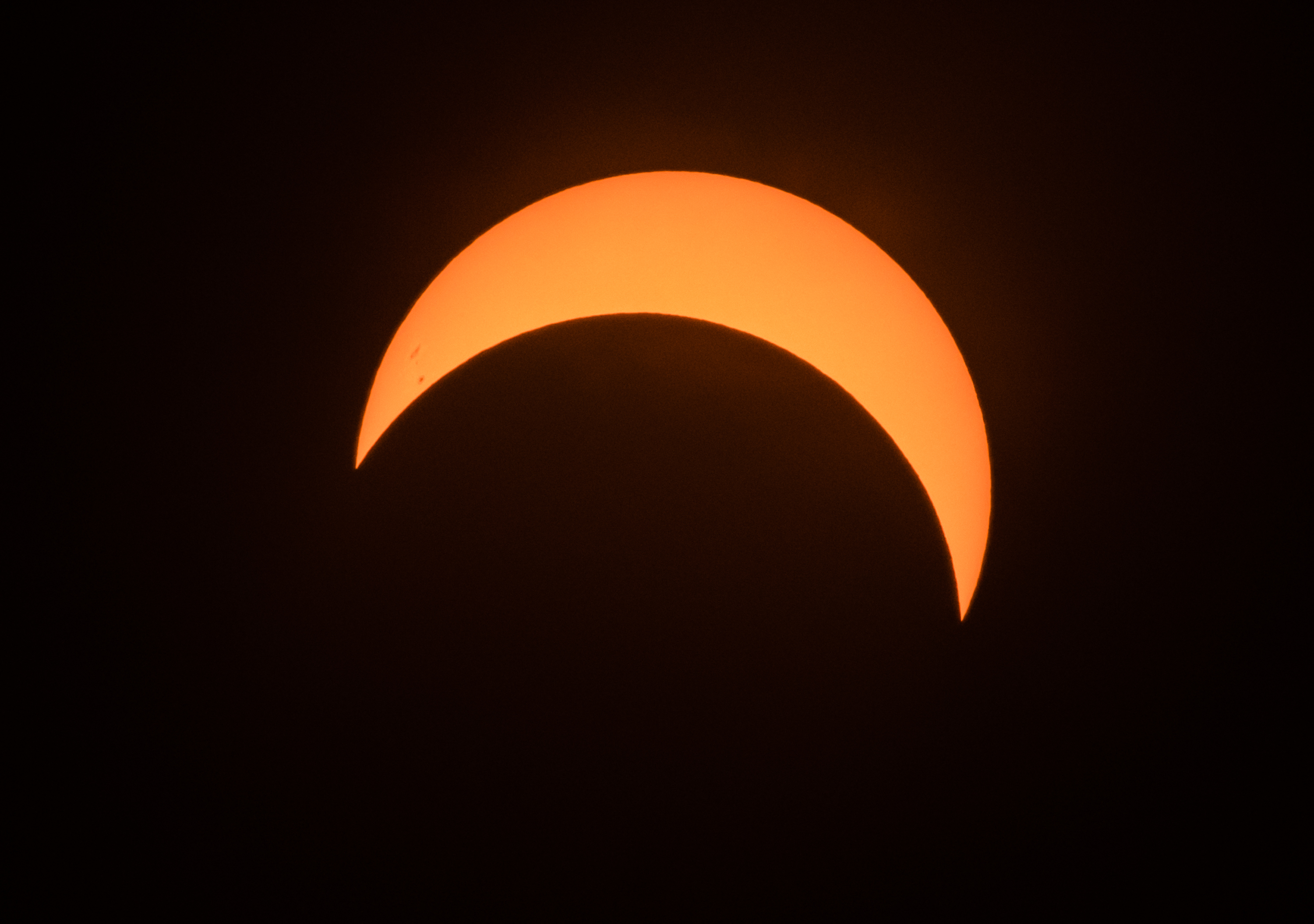 Partial solar eclipse captured during peak moment