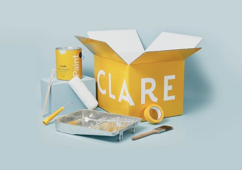 Paint can, tray, roller, and brush with open CLARE box, showcasing painting supplies for home improvement