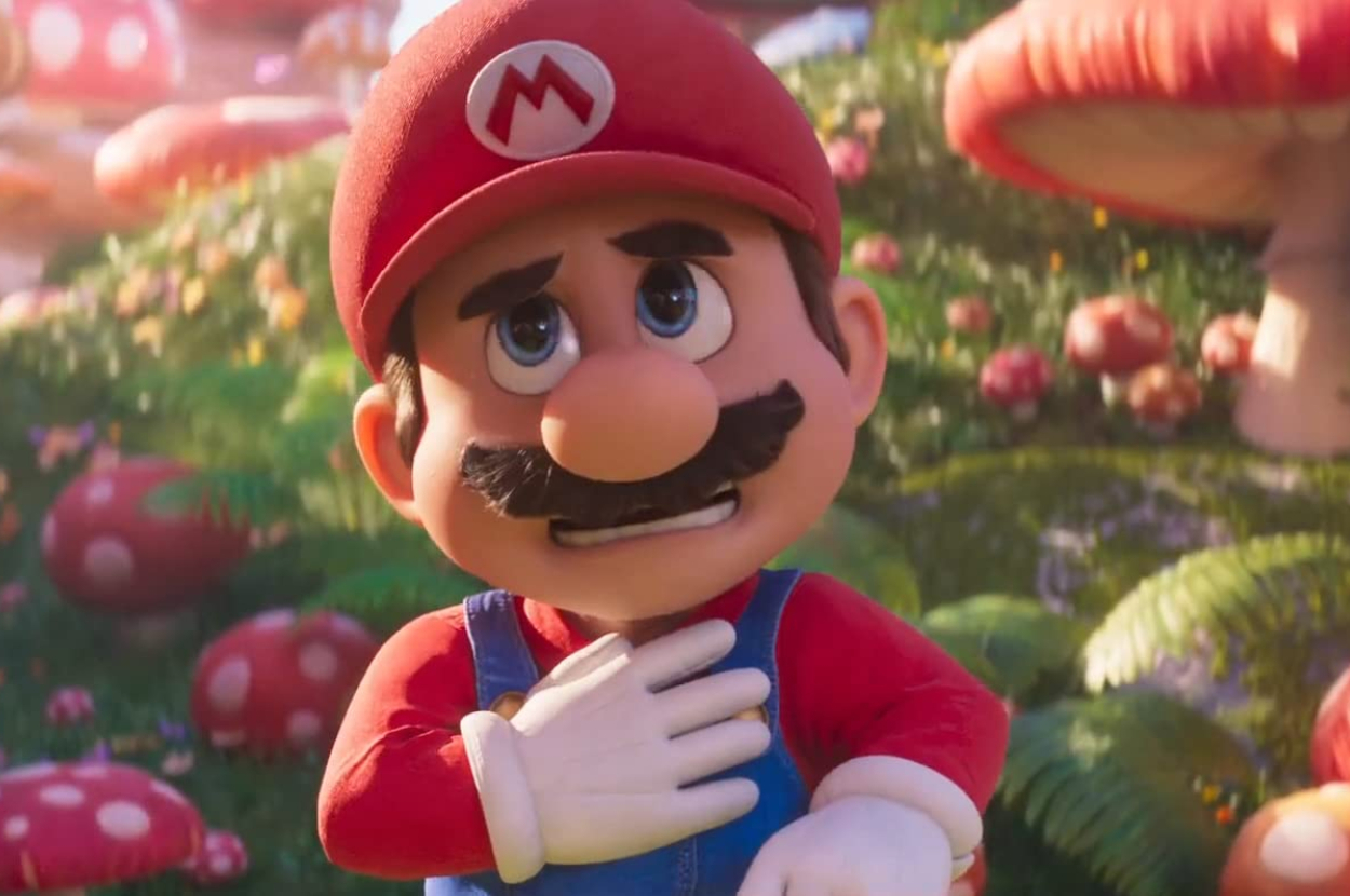Mario from Super Mario in a 3D animated style stands with hand on chest and a surprised expression