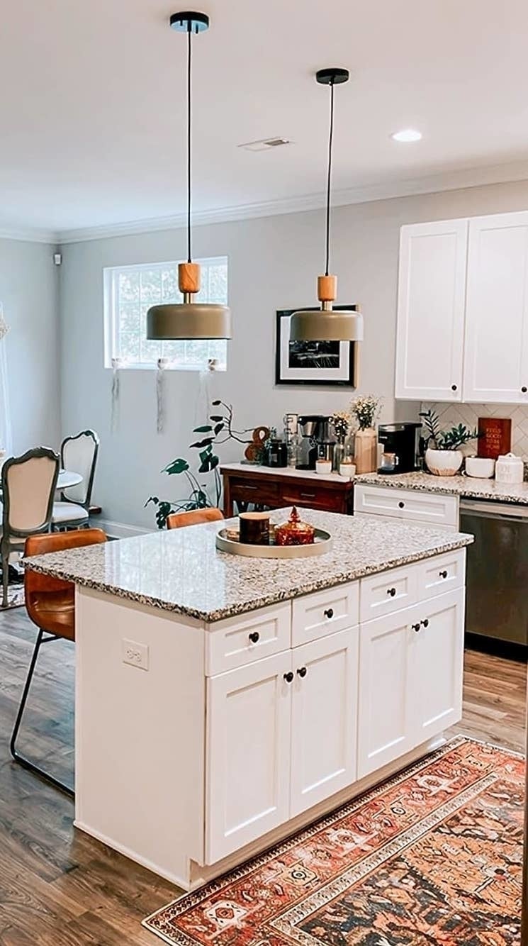 reviewer's two modern pendant lights hanging over kitchen island