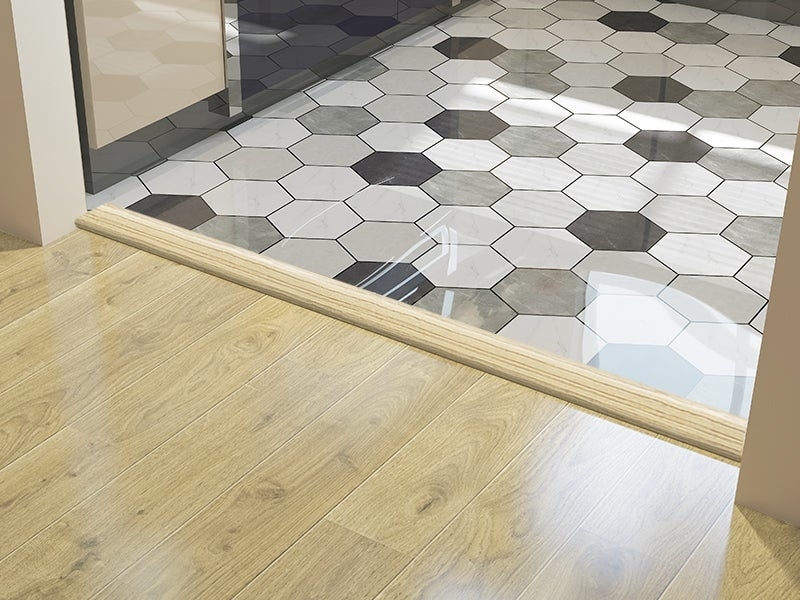 Transition between wooden floor and hexagonal tiled floor, highlighting different flooring types for interior design