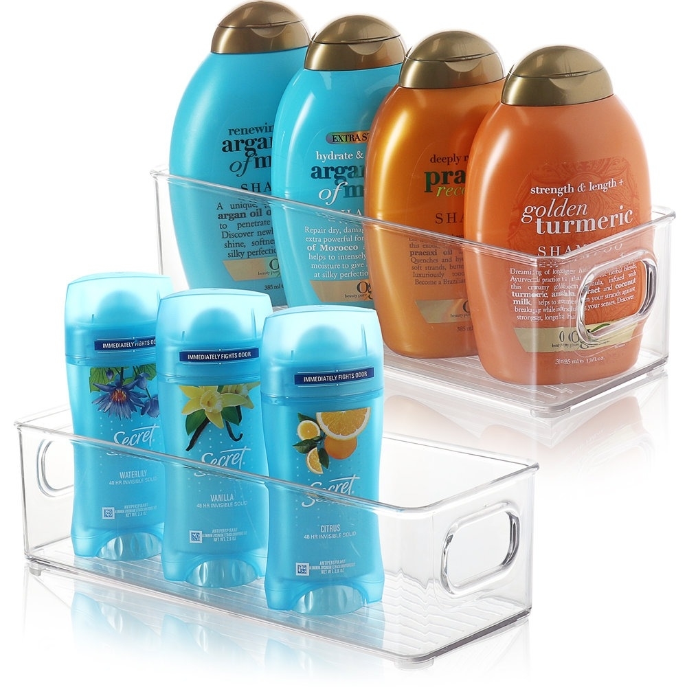 Various shampoo and conditioner bottles organized in a clear storage container