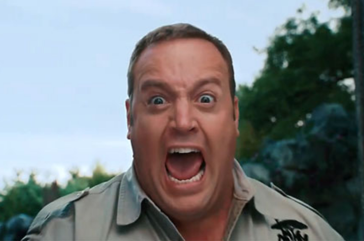 Man with shocked expression, wearing a park ranger uniform, mouth wide open as if yelling or surprised