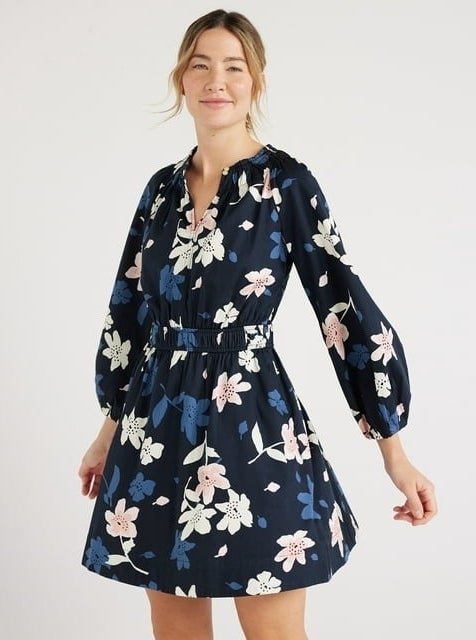 model in a floral print dress with long sleeves and a tie waist