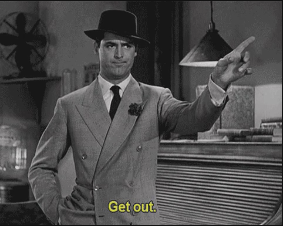 Man in a suit and hat pointing towards the door with the text &quot;Get out.&quot;