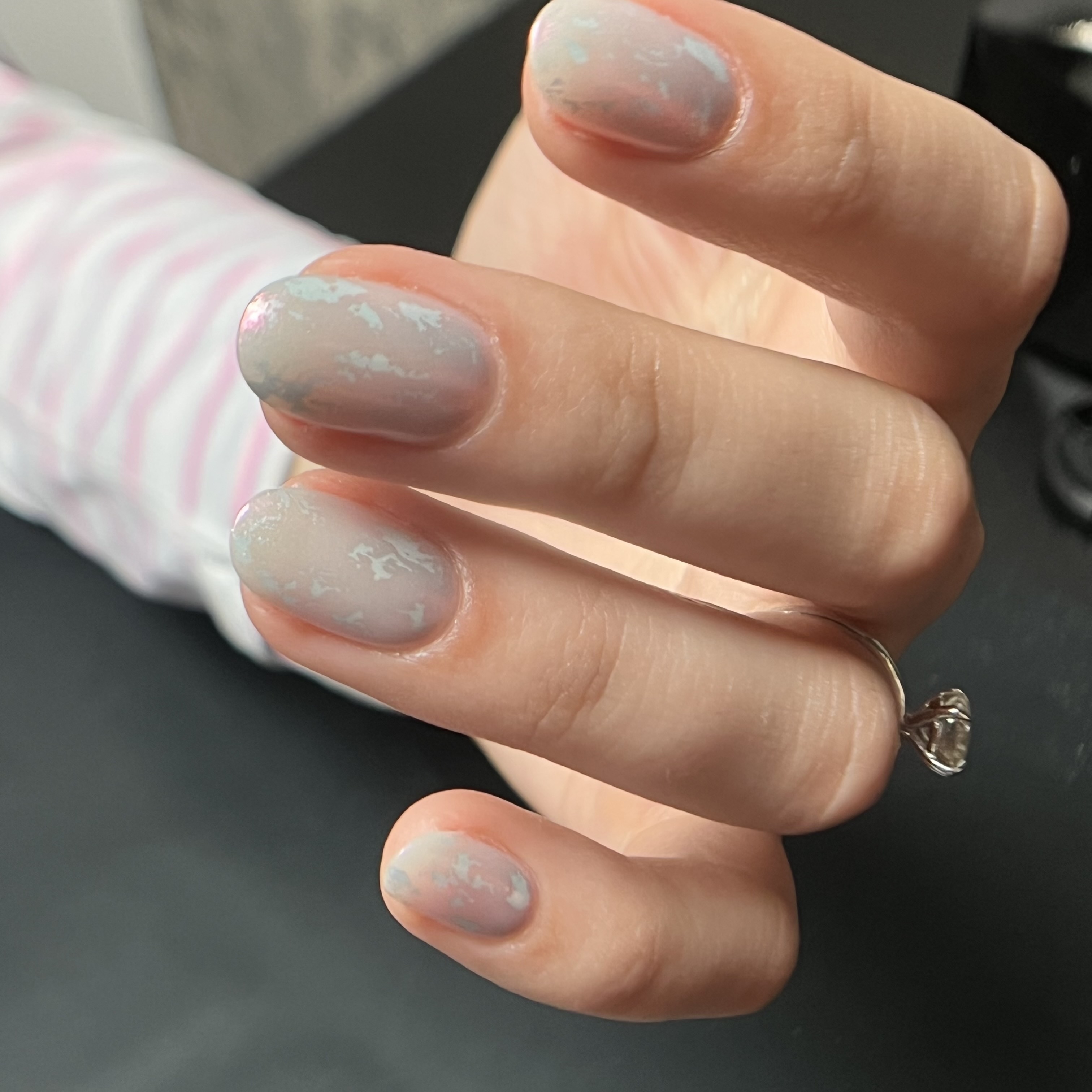 up-close photo of white nails with a design