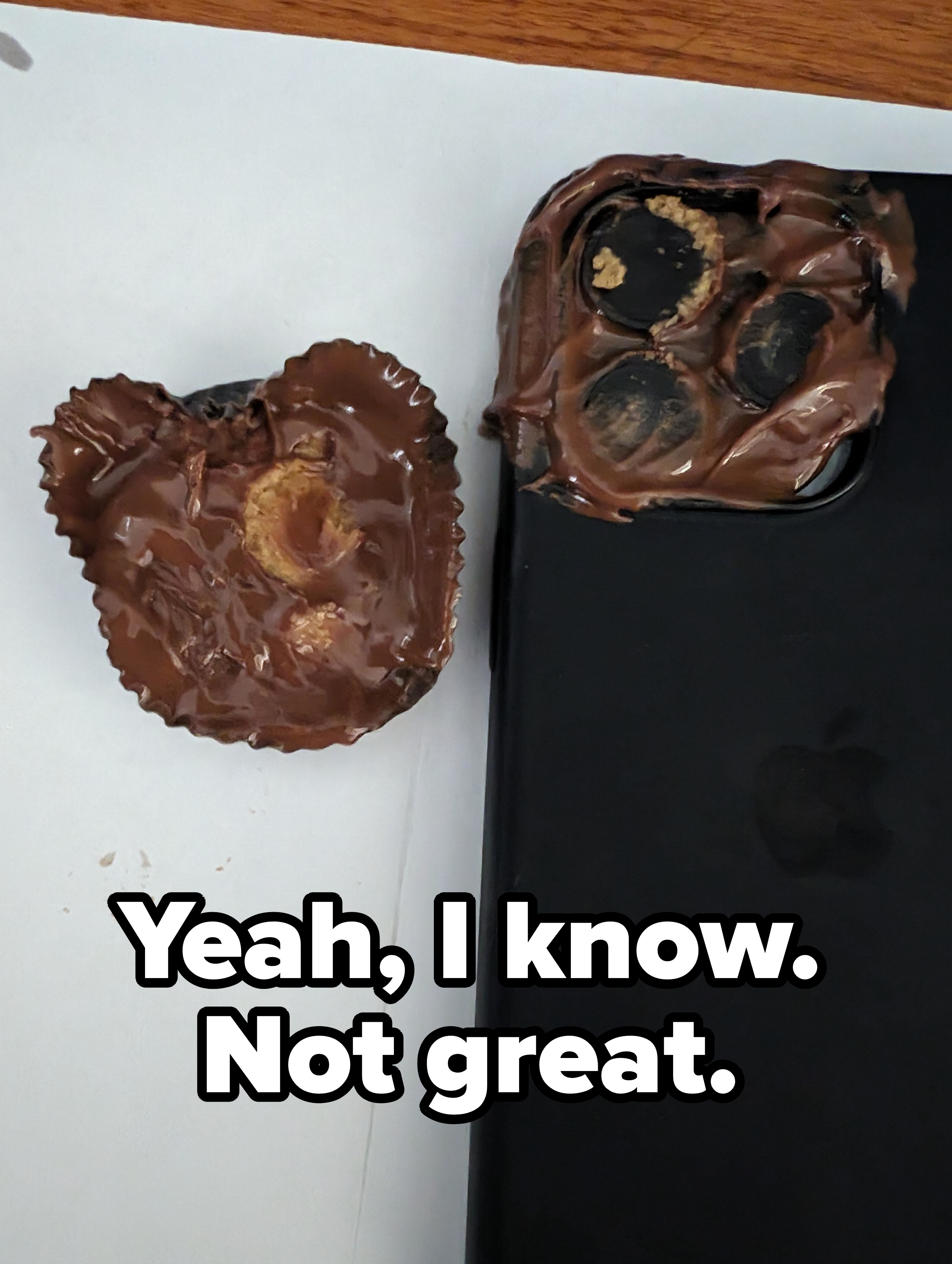 Chocolate in the shape of a bitten heart next to a smartphone