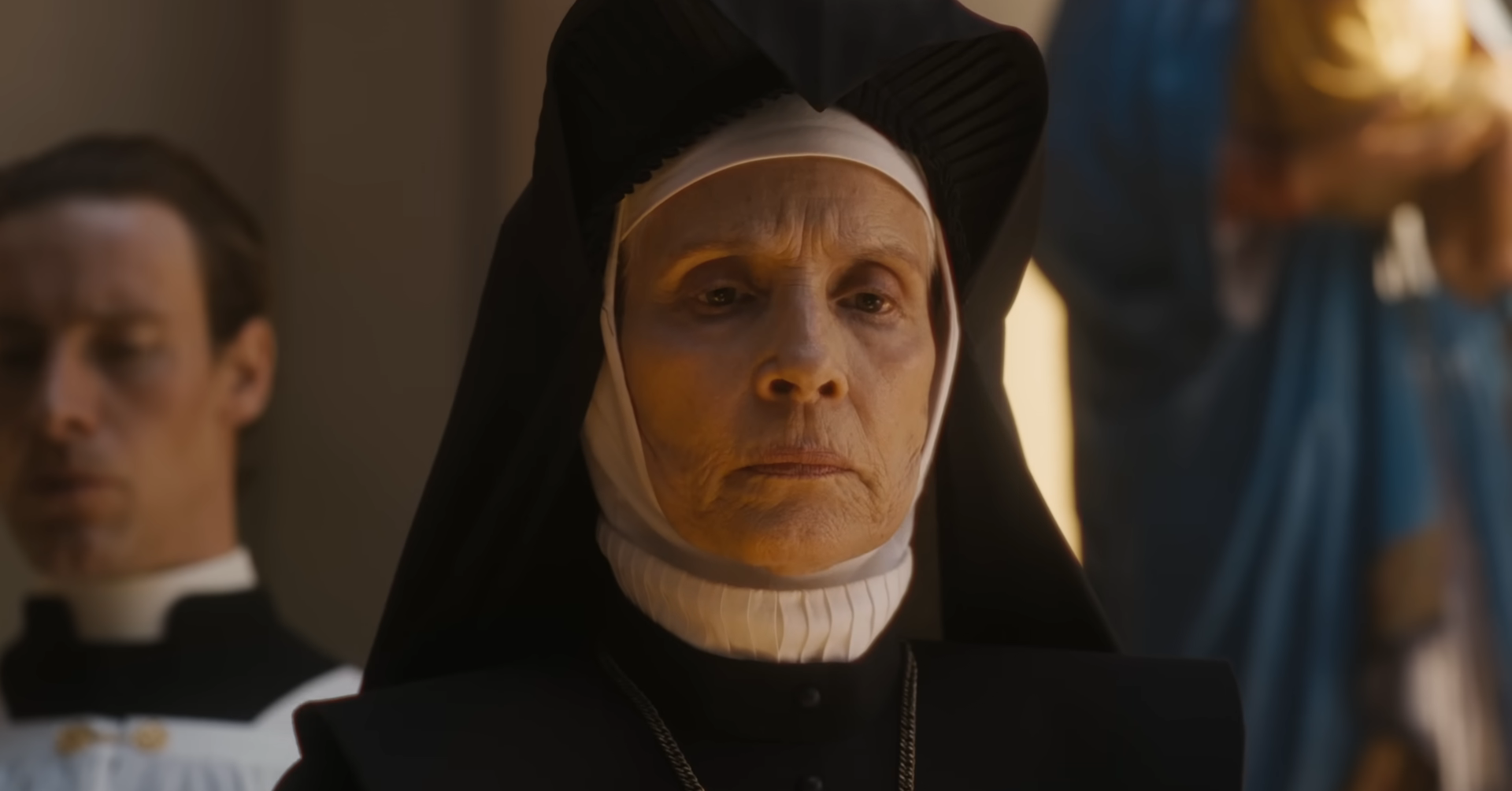 Character in nun attire with solemn expression, part of a scene in a film