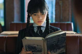 Wednesday Addams reading a book