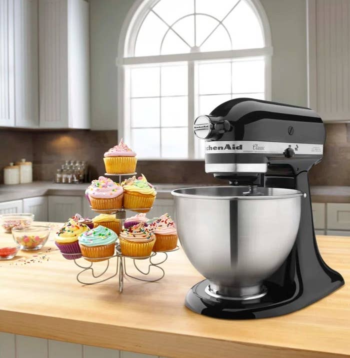 KitchenAid stand mixer on countertop with cupcakes in front