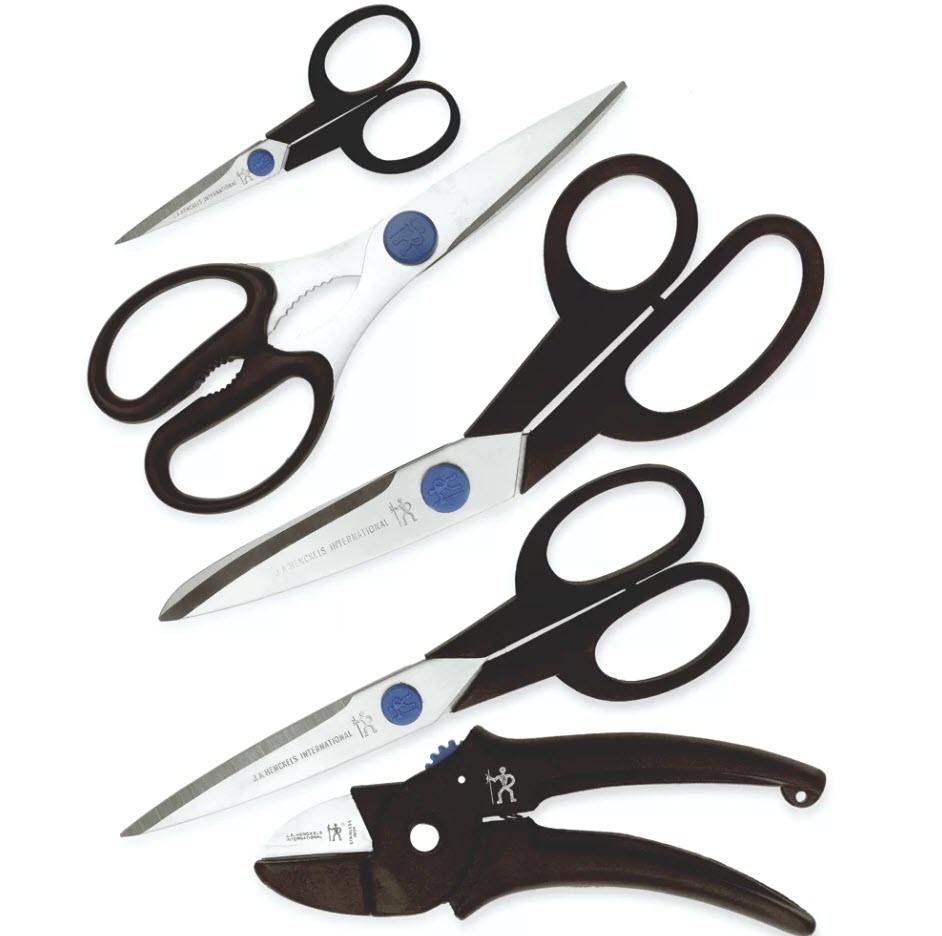 Four different pairs of scissors with black handles, arranged in a fan pattern