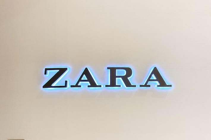 Storefront sign with &ldquo;ZARA&rdquo; in capital letters and a fire alarm switch below to the left