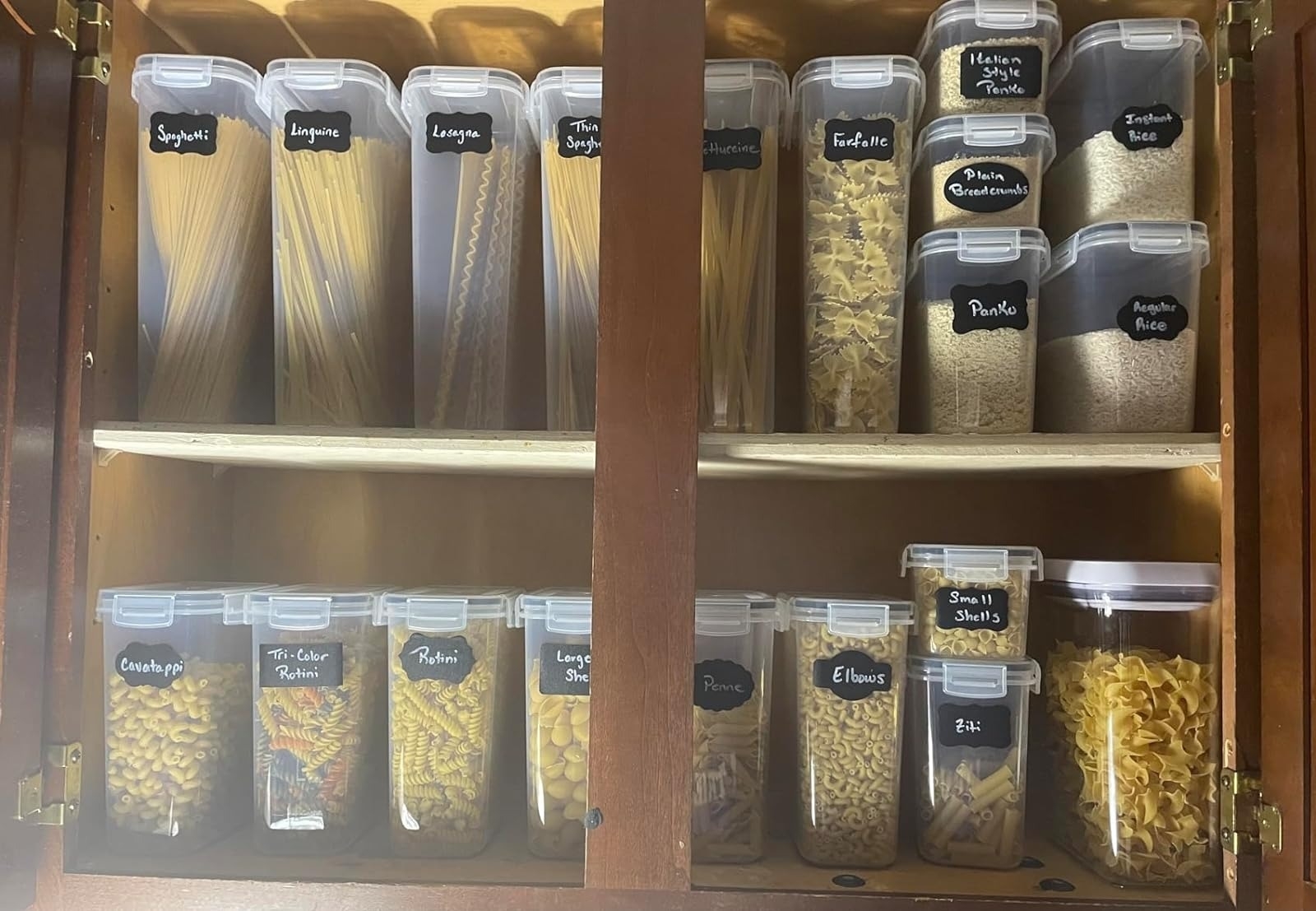 Organized pantry shelves with labeled containers for various pasta and grains