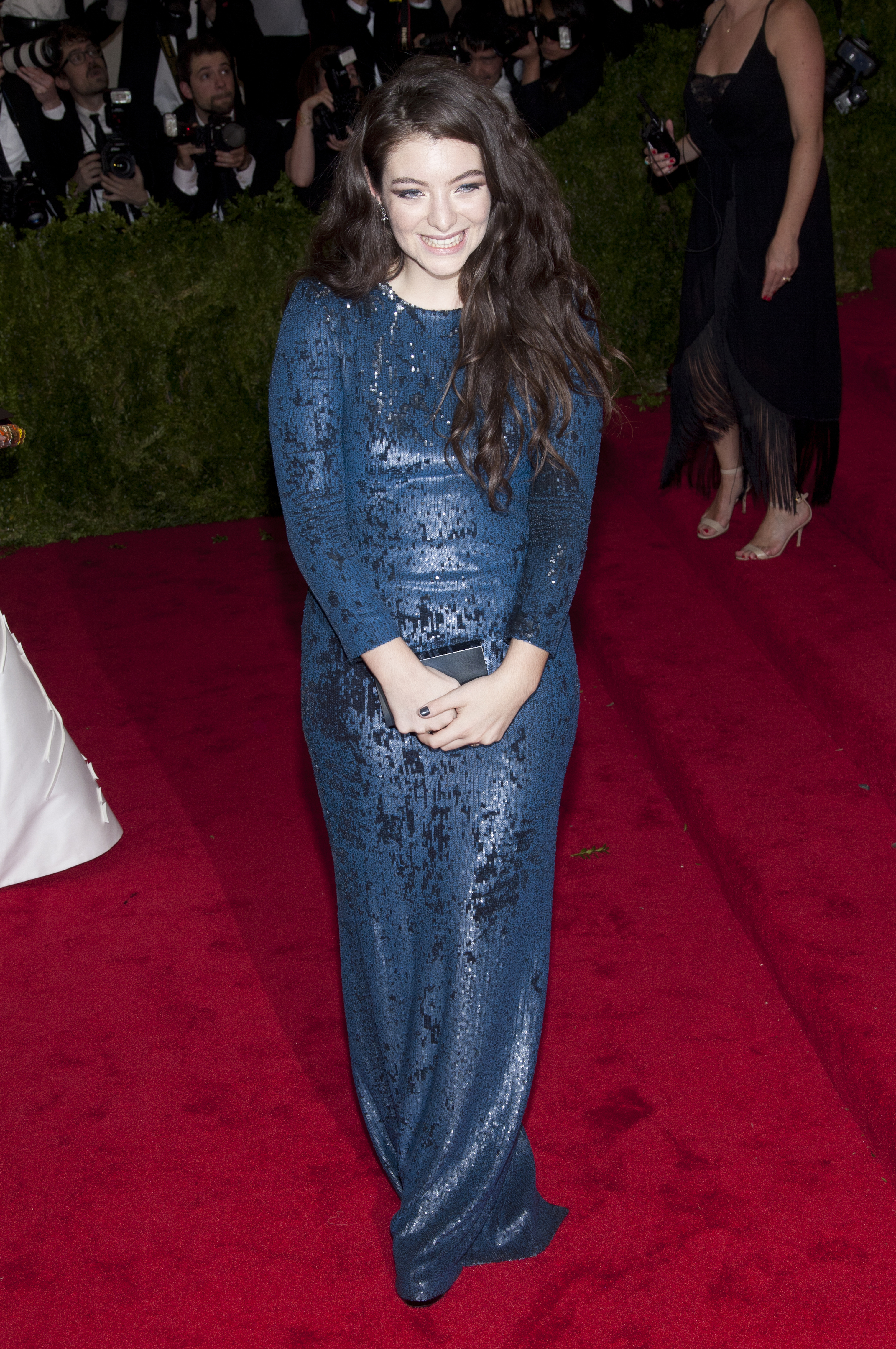 Lorde in a long-sleeved, sequined gown at a red carpet event