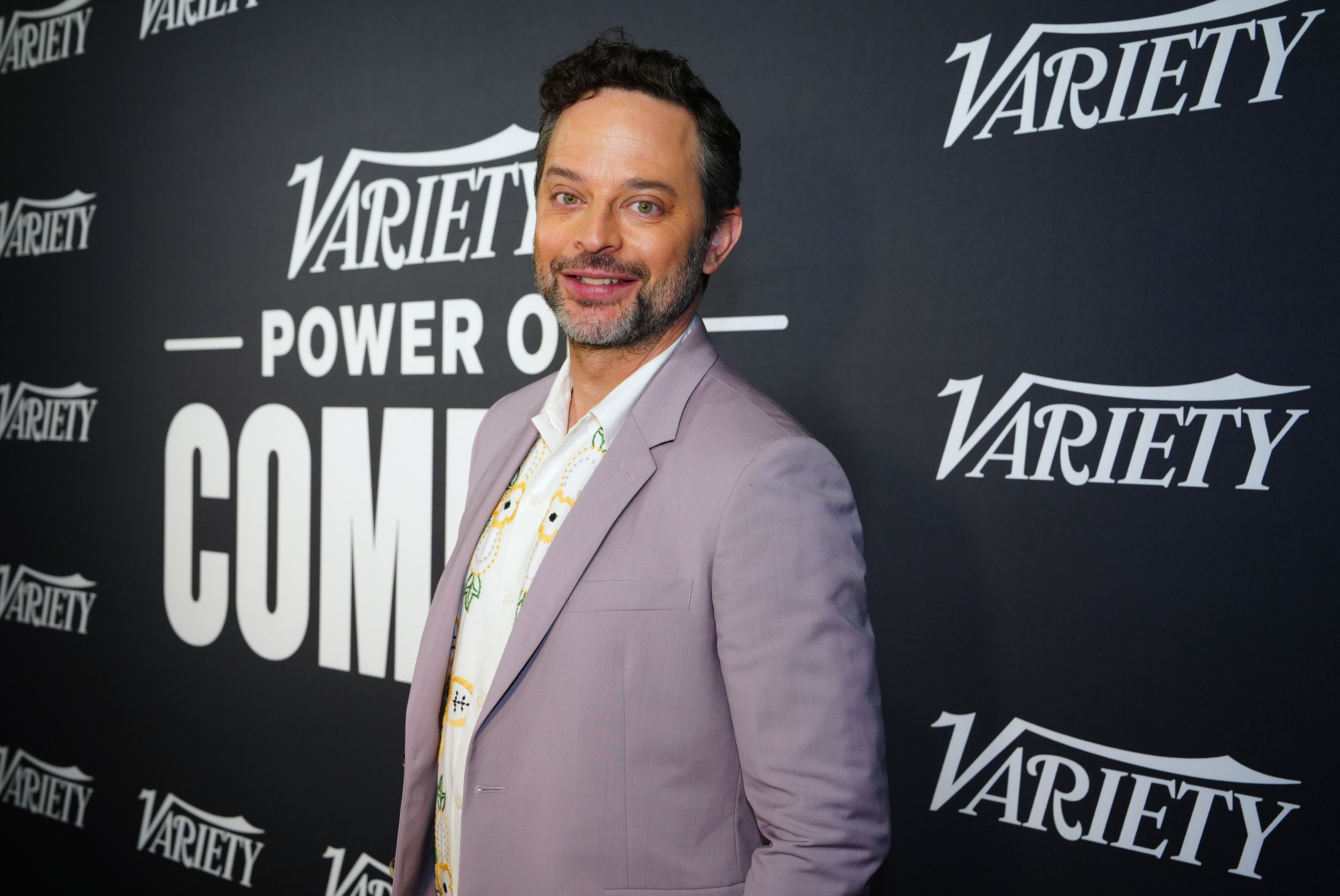 Nick Kroll poses at Variety&#x27;s Power of Comedy event wearing a light jacket and patterned tie