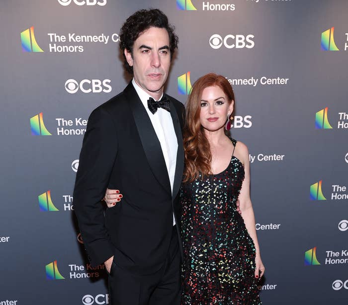 Two celebrities on the red carpet; the man wears a black tuxedo and the woman a sequined gown