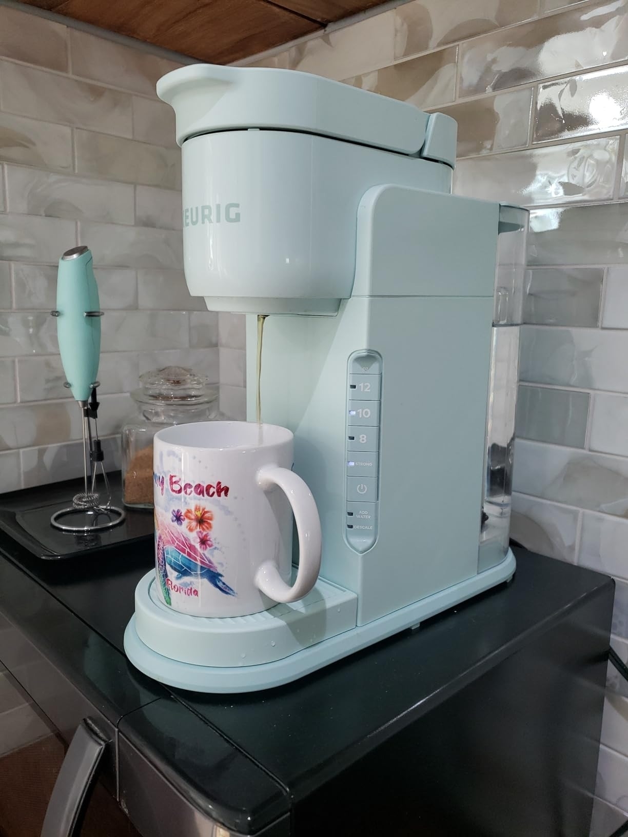 Keurig machine dispensing coffee into a mug