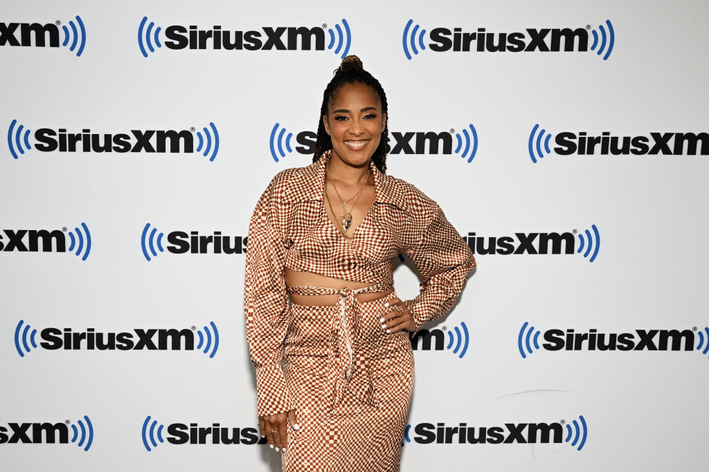 Amanda Seales poses in a checkered outfit at the SiriusXM studio