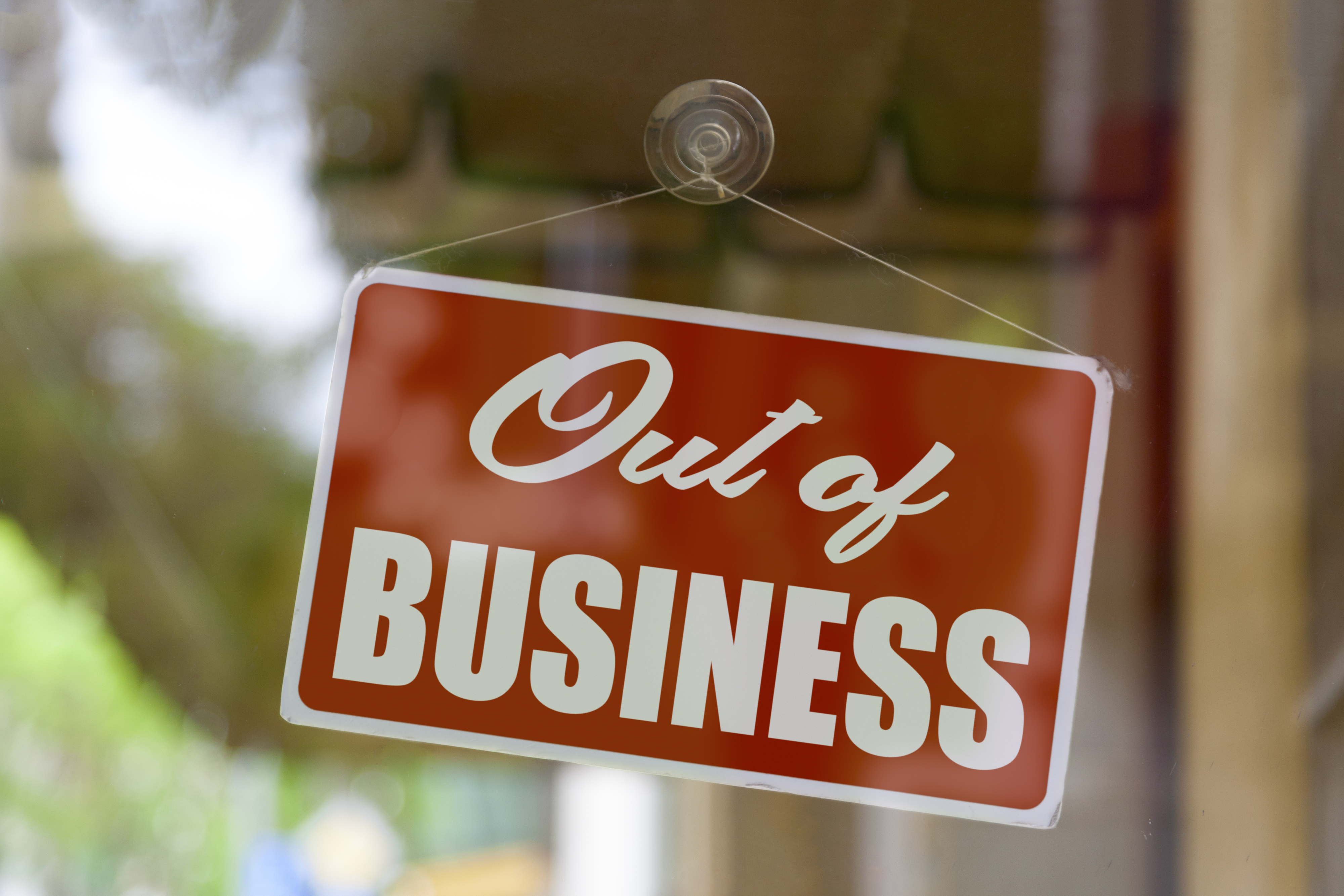 Sign on glass door reads &quot;Out of Business&quot;
