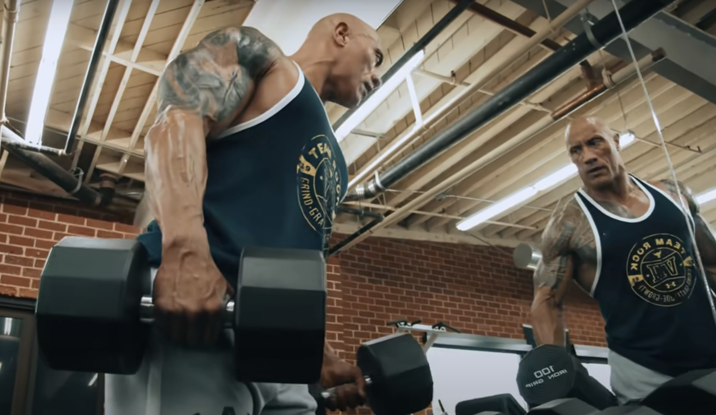 Dwayne Johnson lifting weights in a gym, reflecting focus and determination for fitness