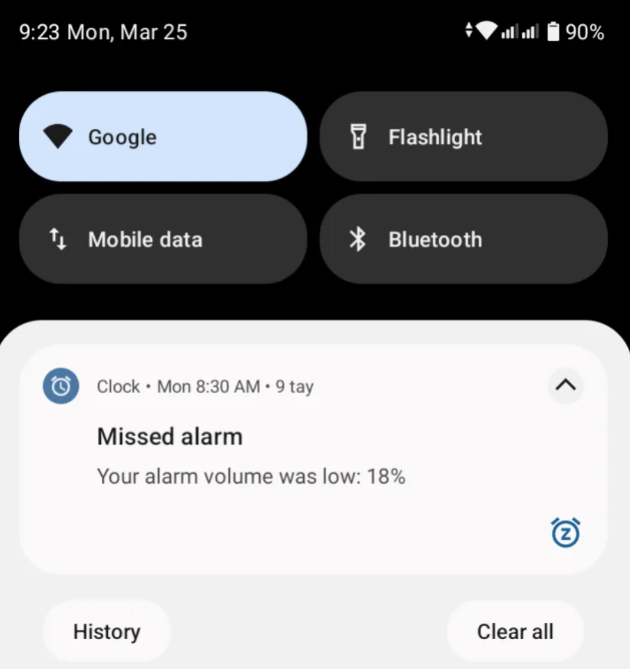 Smartphone screenshot showing a notification about a missed alarm due to low volume, with Bluetooth and data toggled on