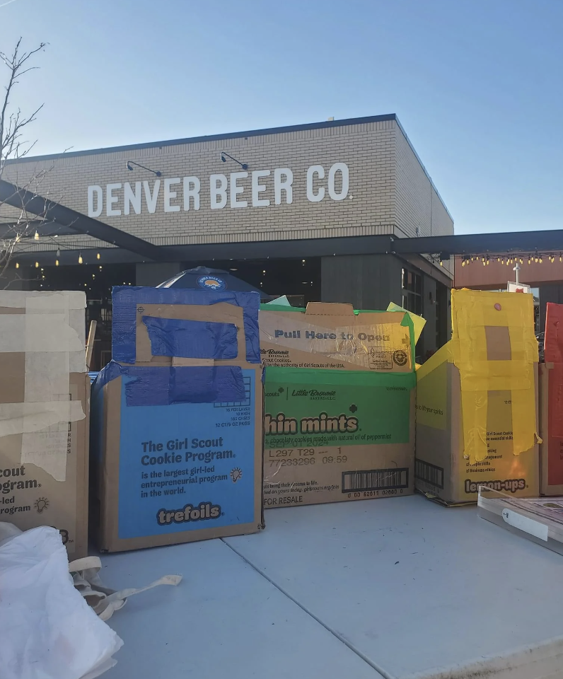 Stack of Girl Scout cookie boxes outside Denver Beer Co brewery