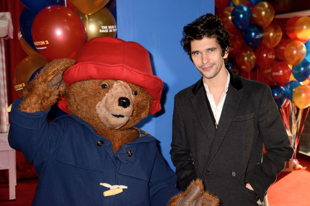 Ben Whishaw next to a giant Paddington bear