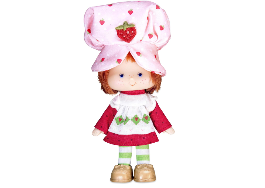 Doll with a large bow, freckles, wearing a dress with strawberries, and striped tights