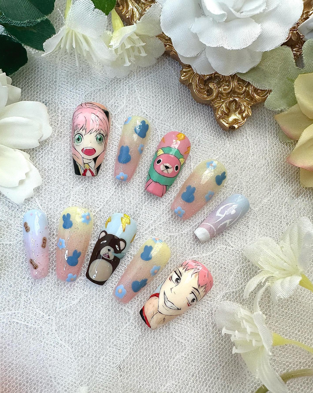 Nail art designs featuring various cartoon characters and clouds on a lace background, showcasing intricate detail.
