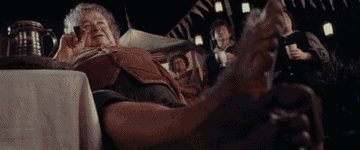 Bilbo Baggins disappears from his birthday party in a scene from a fantasy film