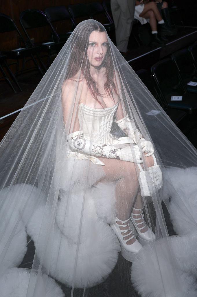 Julia Fox at an event wearing a corsetting wedding dress with large veil