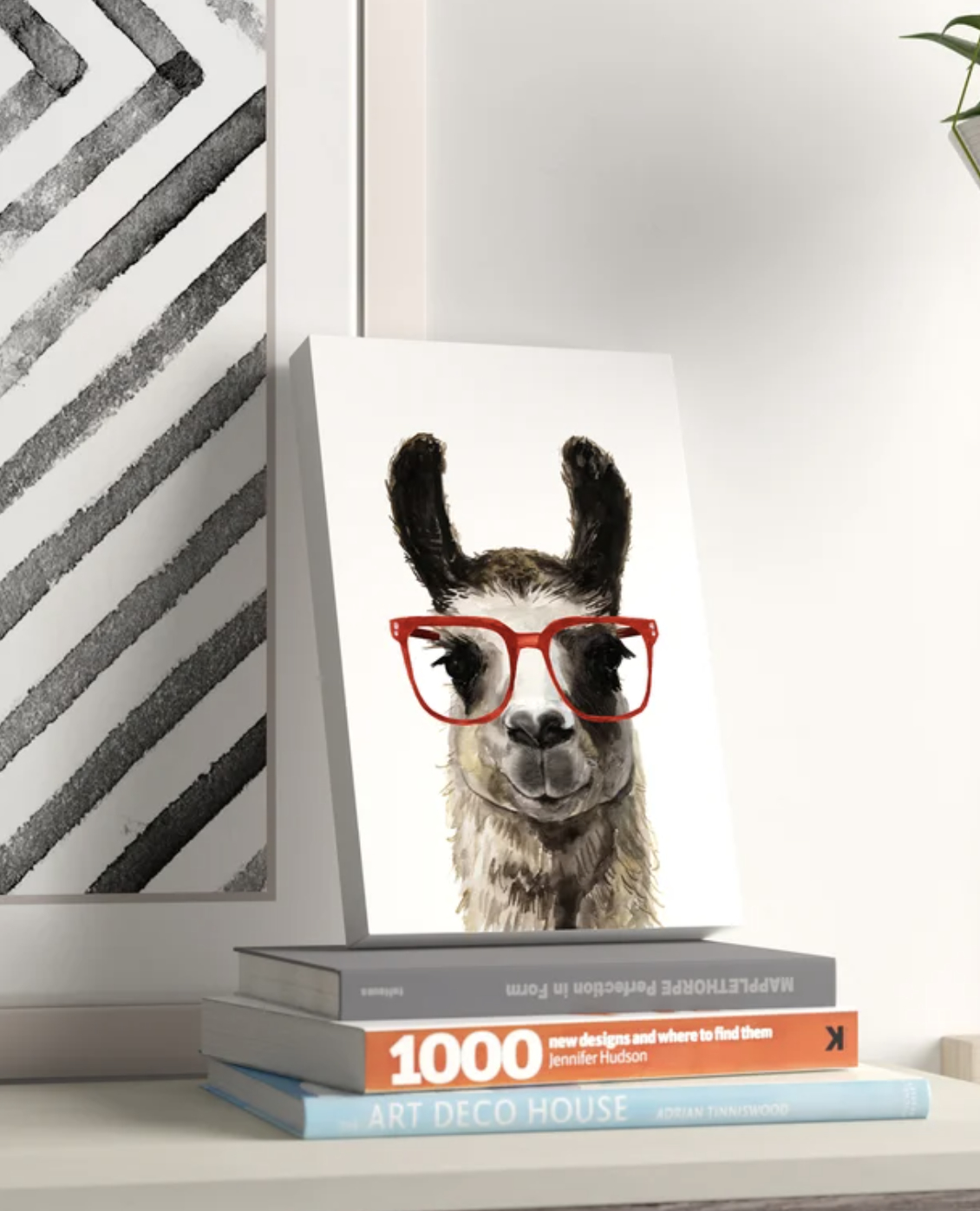 Print of a llama with red glasses, set on a bookshelf beside a stack of books