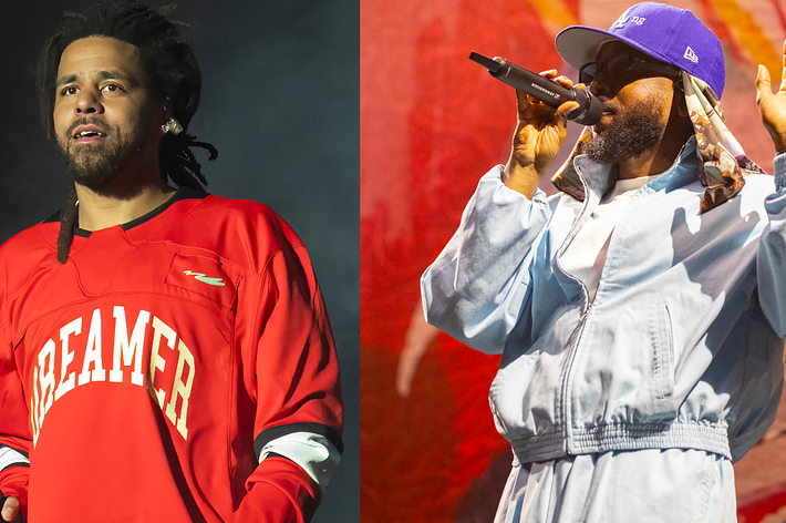 Two male musicians perform on stage, one in a red "DREAMER" jersey and the other in a light blue outfit with a cap