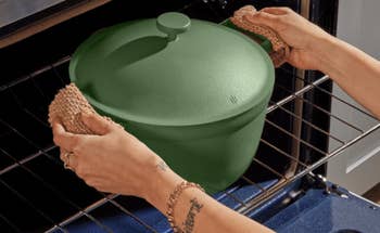 Person grips a ceramic pot showcasing its features: nonstick, recycled, oven-safe, and built-in strainer.