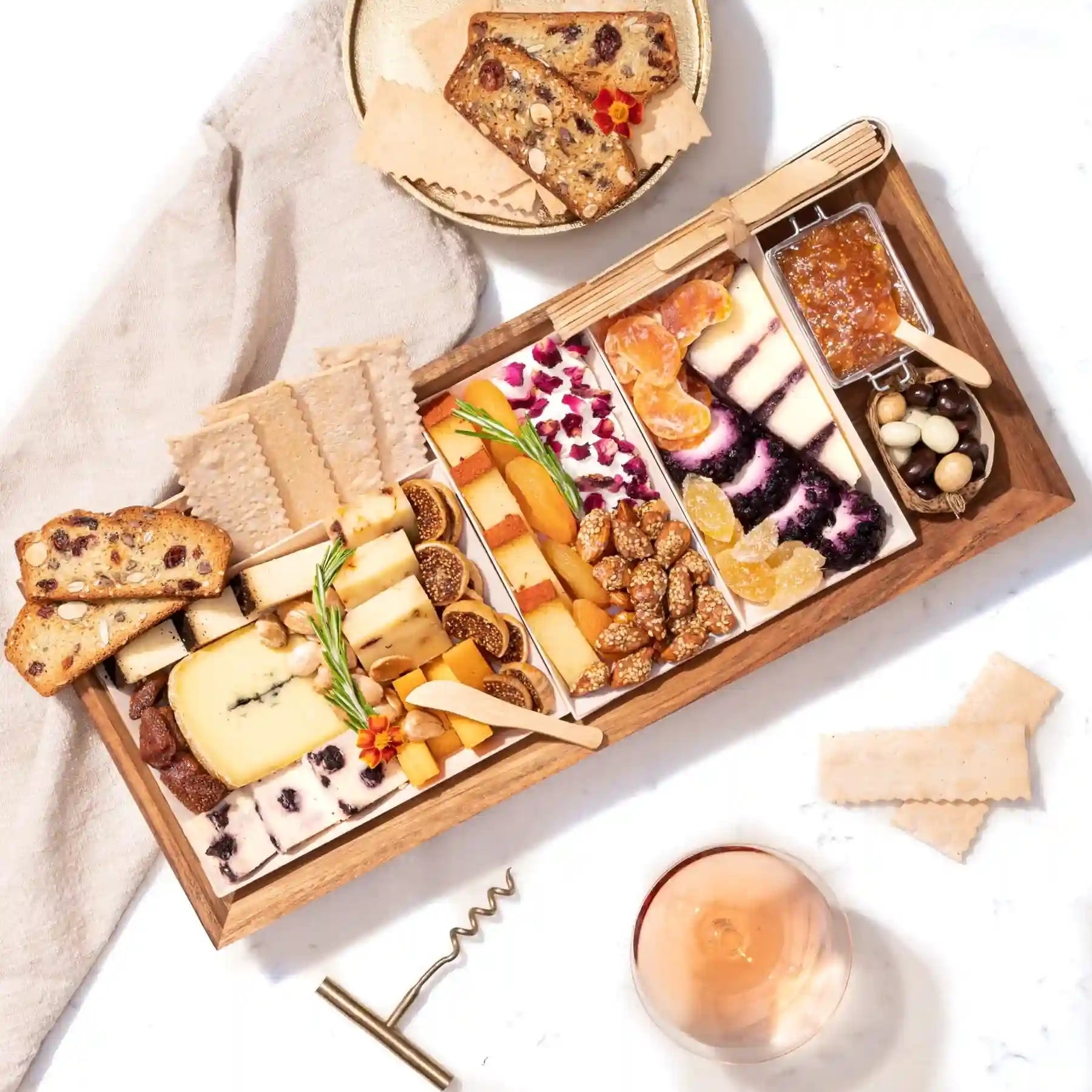 Cheese board with various cheeses, honey, nuts, fruits, and crackers for stylish serving ideas