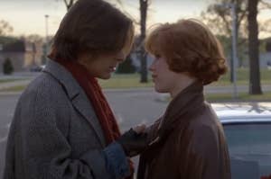 Two characters from the movie Breakfast Club, John Bender and Claire Standish, face each other outdoors
