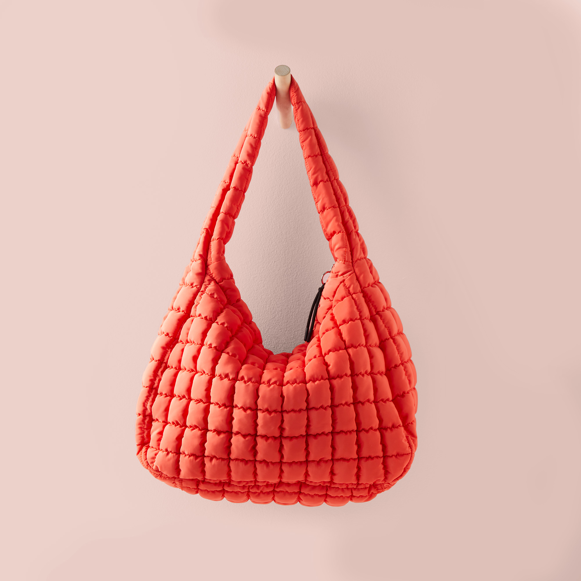 Quilted handbag in a slouchy design with a braided strap, suitable for shopping
