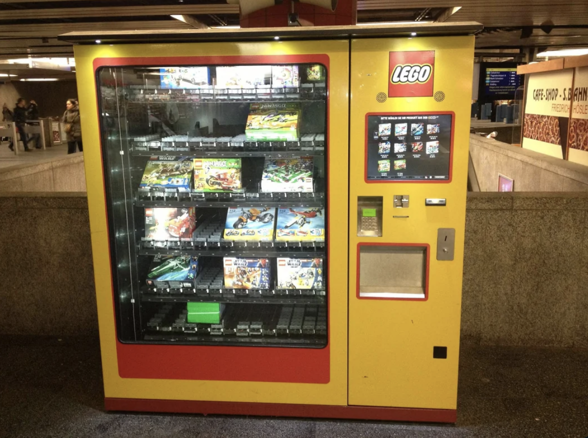 LEGO vending machine filled with various sets, installed in a public space