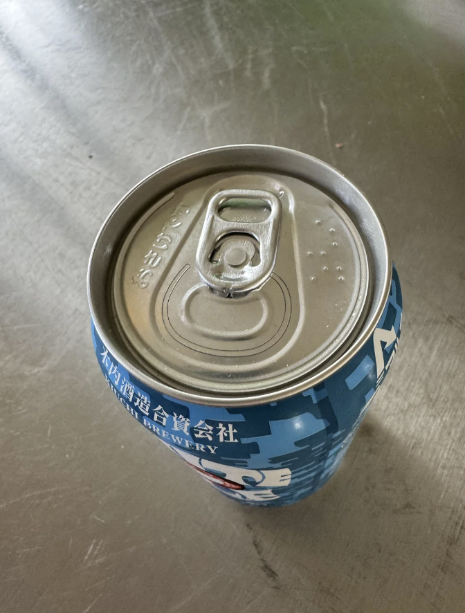 Top view of a closed beverage can with condensation droplets