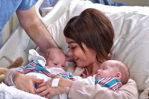 Haley from Modern Family in a hospital bed holding two newborns
